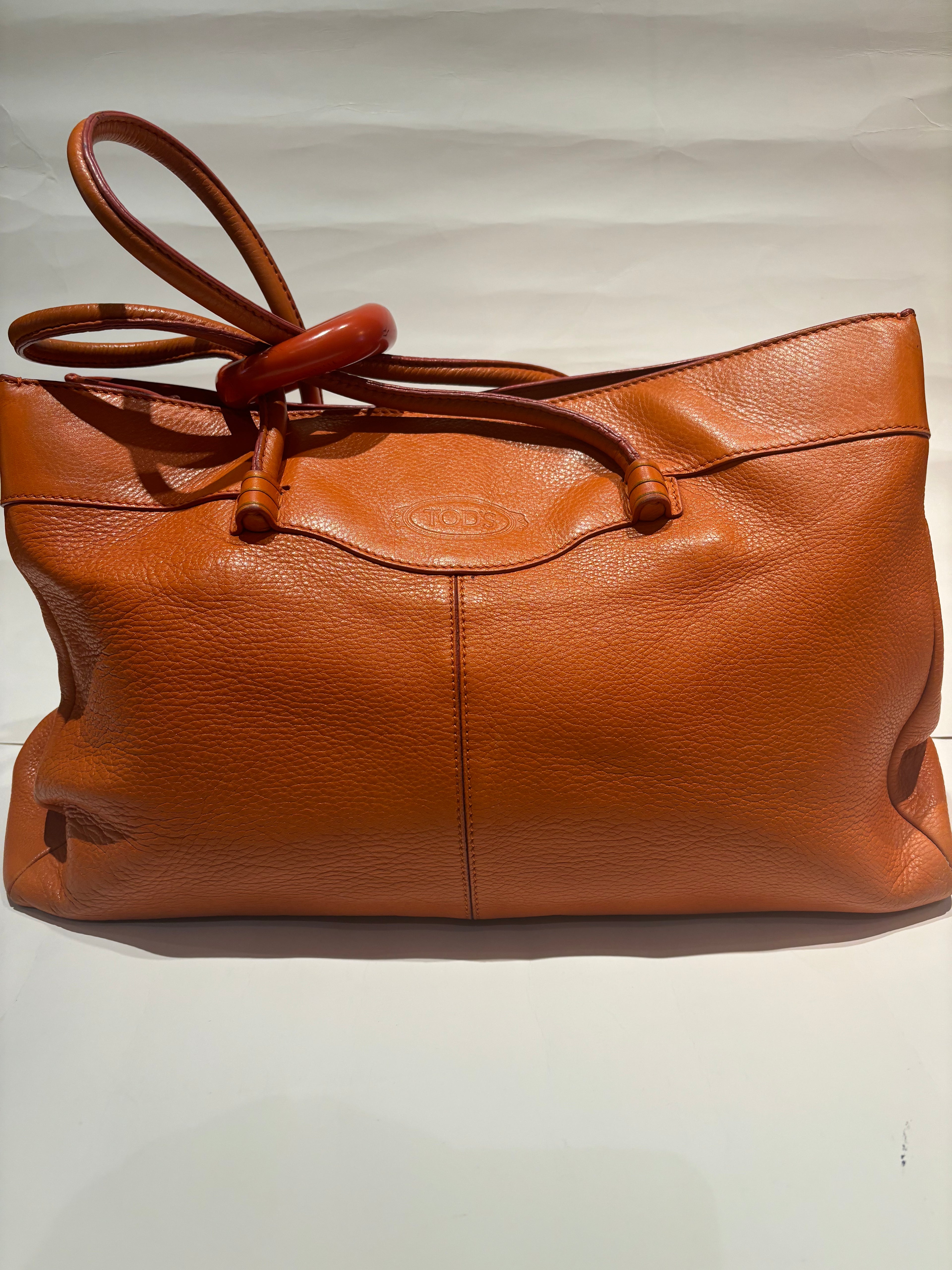 Tod’s orange leather pebble tote bag